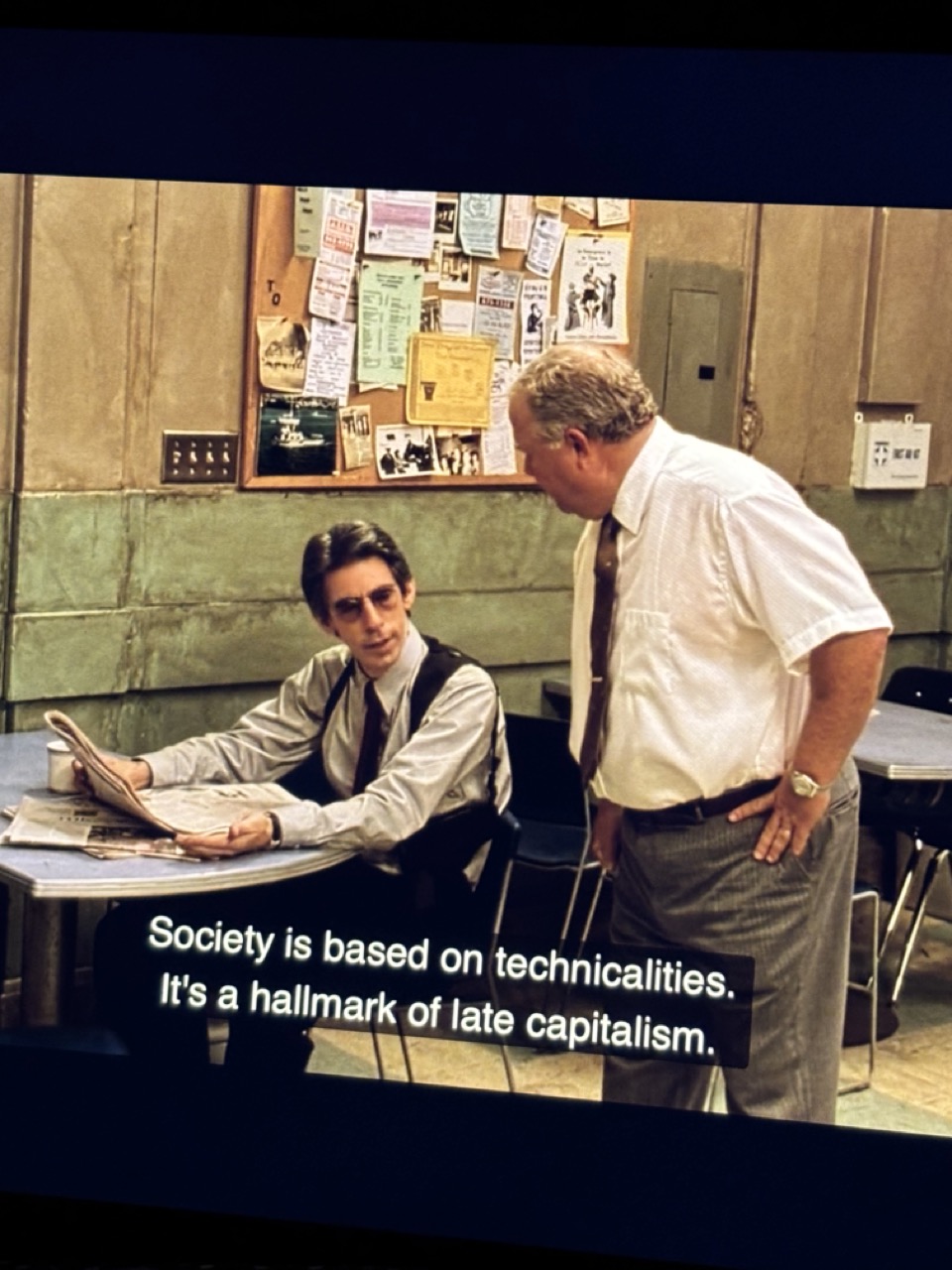 Still from Homicide: Life on the Street. Subtitle reads: Society is based on technicalities it's a hallmark of late-capitalism